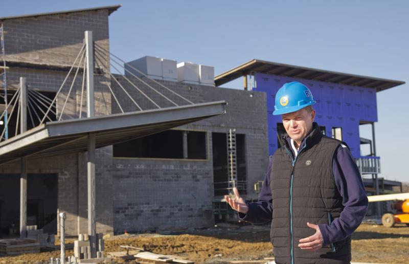 Cape Director of Capital Projects Brian Bassett stands in front of what will be the Consortium’s student drop-off area. The overhang will resemble the Indian River Inlet bridge and will be illuminated blue for autism awareness. A biometric reader will notify staff to come escort students inside. DENY HOWETH PHOTO